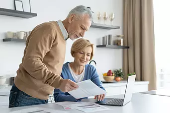 Texas couple reviewing their estate planning documents in front of their open laptop computer