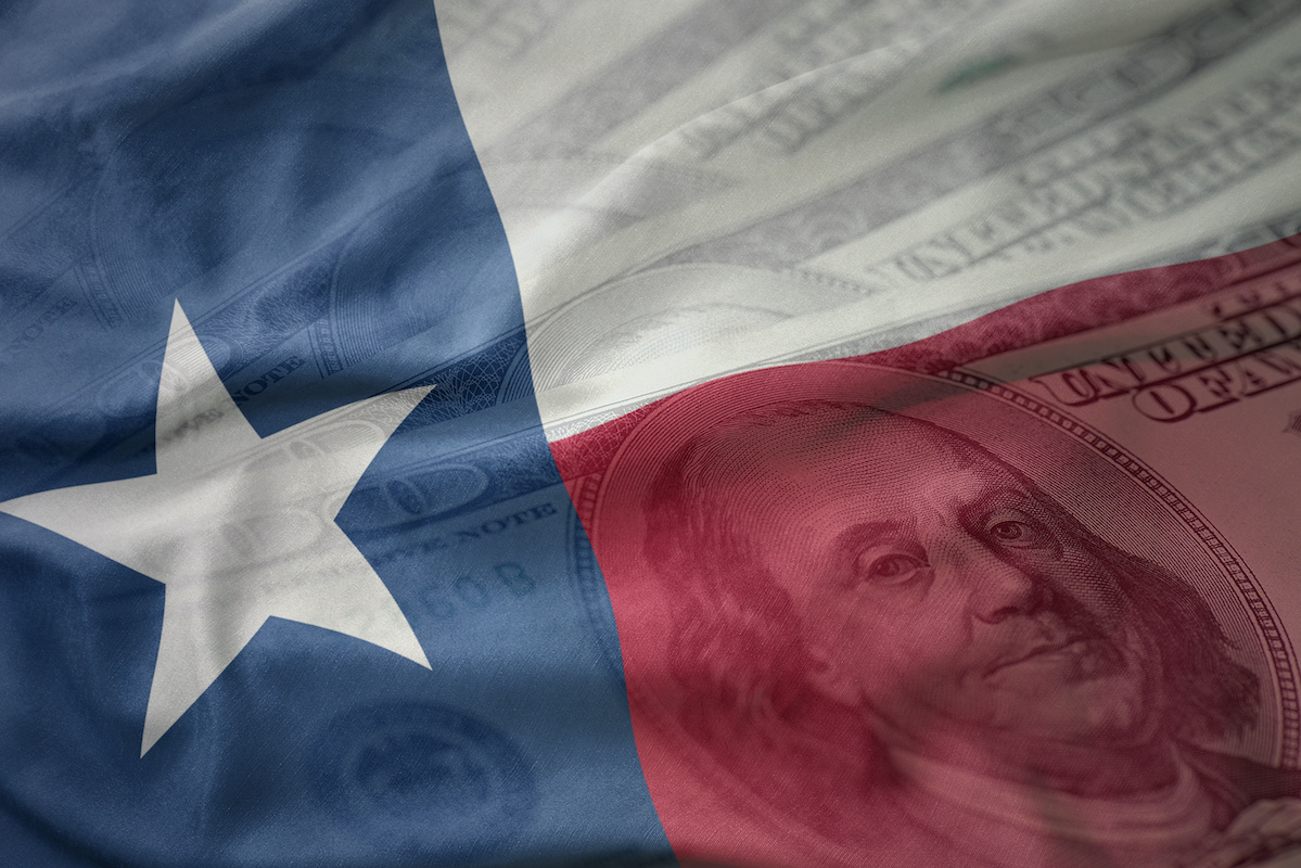 Texas flag superimposed onto the images of US 100 dollar bills representing financial planning in San Antonio